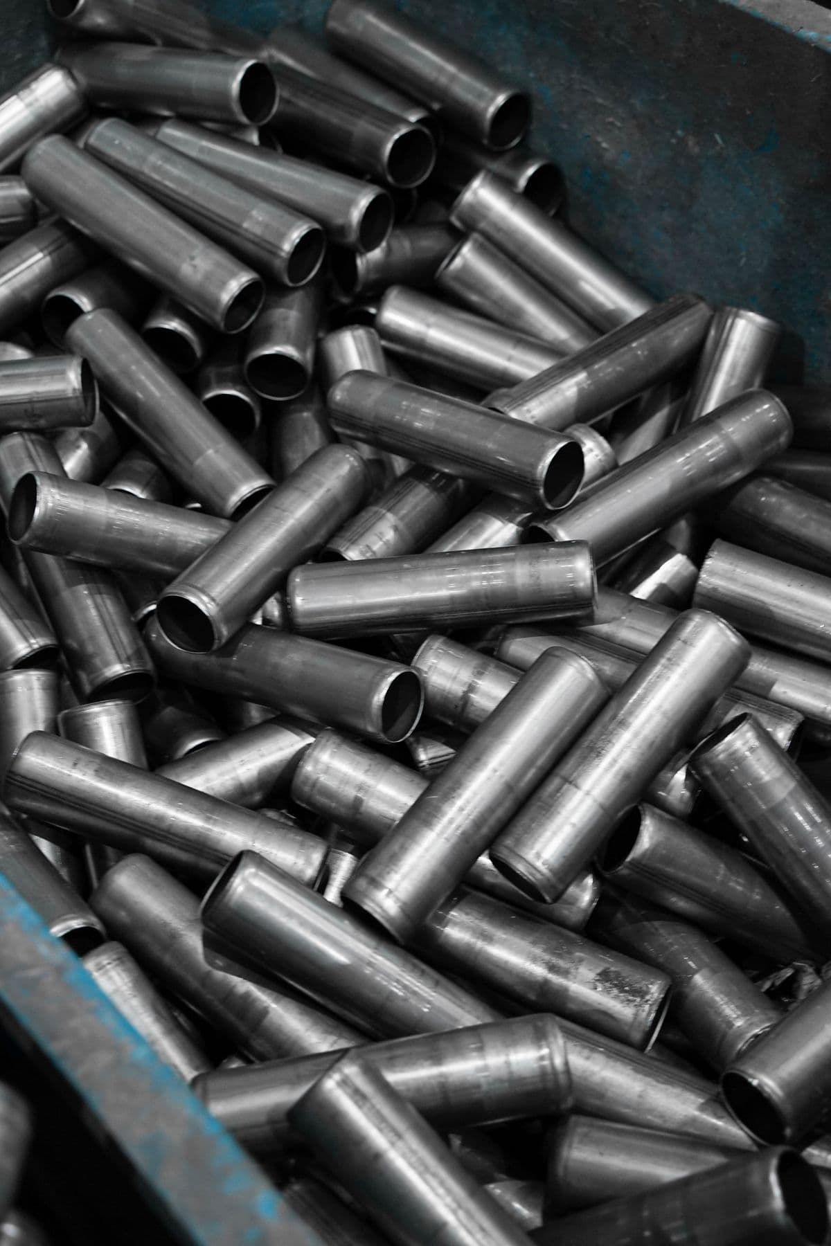 Stacked stainless steel pipes in an industrial warehouse