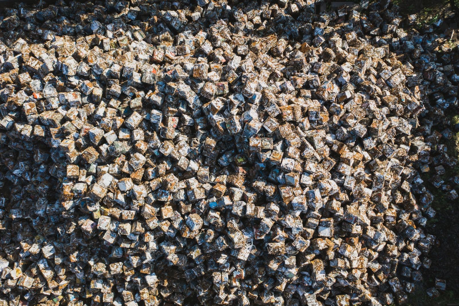 Aerial view of baled metal scrap cubes in an industrial yard
